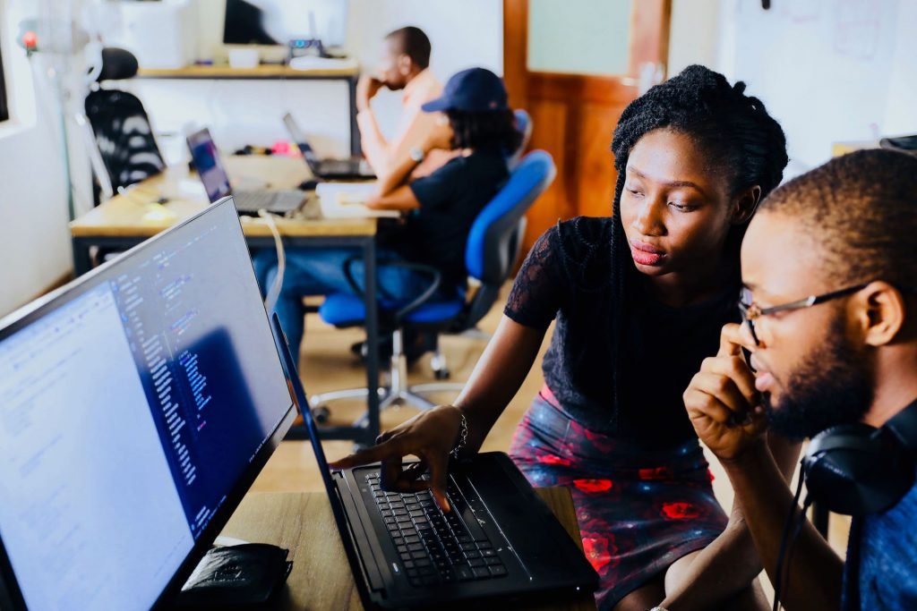 man and woman learning at computer