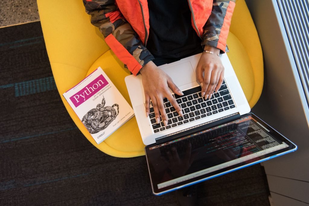 woman reading python working laptop